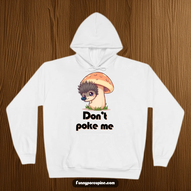 Funny hoodie showcasing a spiky porcupine's curious peek from behind a large, playful mushroom design, expressing sheer amusement.