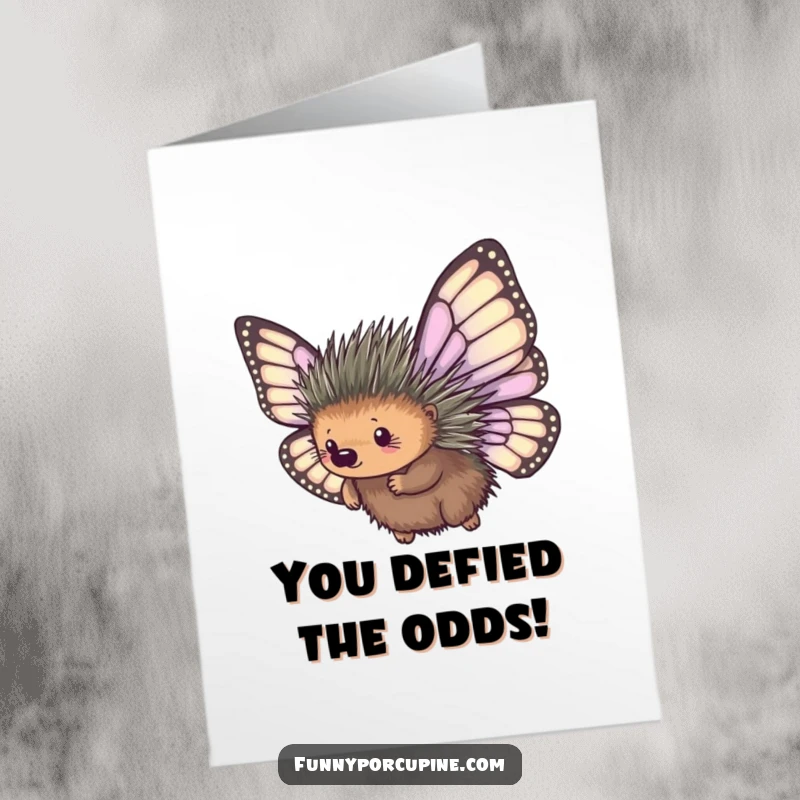 Funny Free Printable Congratulations Card: A porcupine bravely leaps with huge, floppy butterfly wings, promising a comical landing.